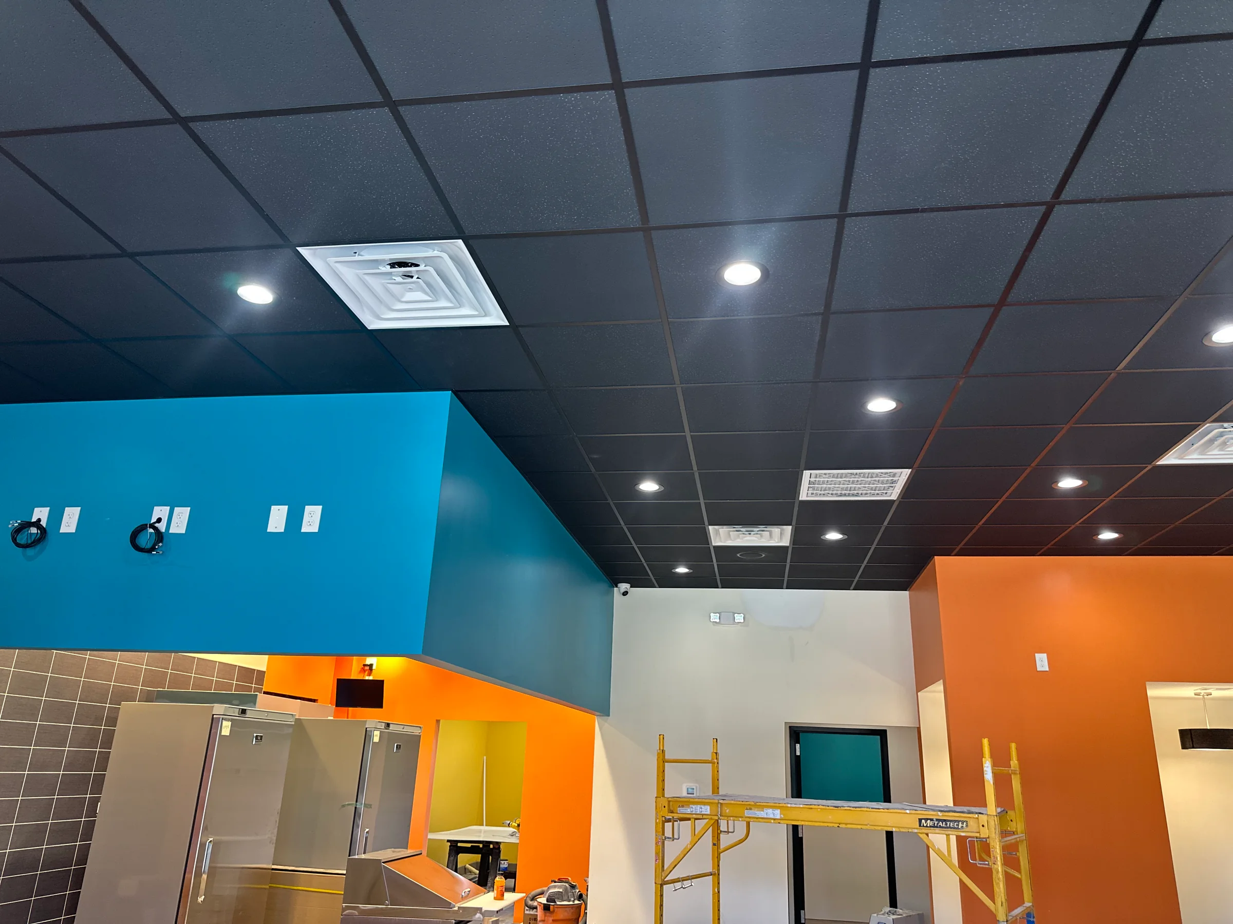 Blue, orange, and yellow wall finishes in a commercial interior