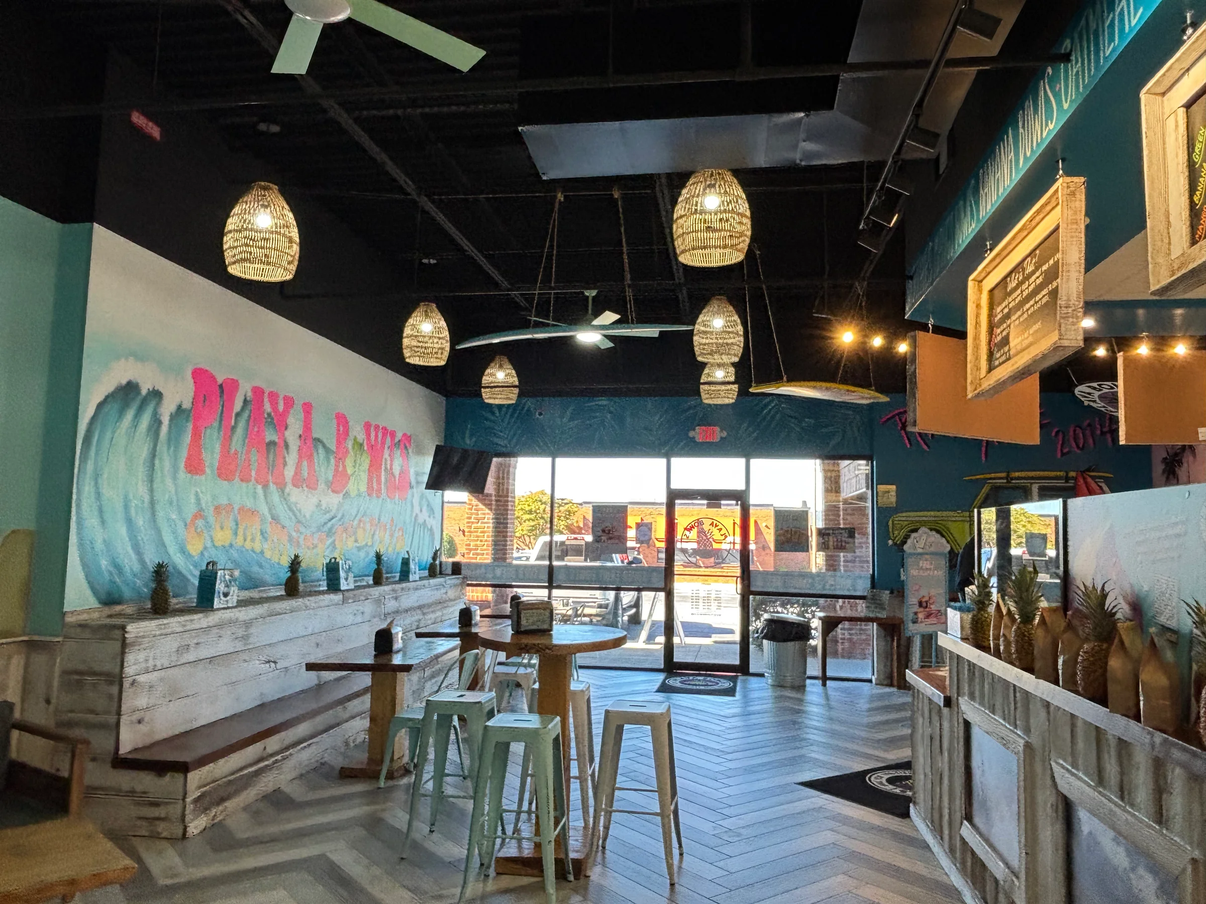 Restaurant interior with pendant lights, wall finishes, and built-in seating