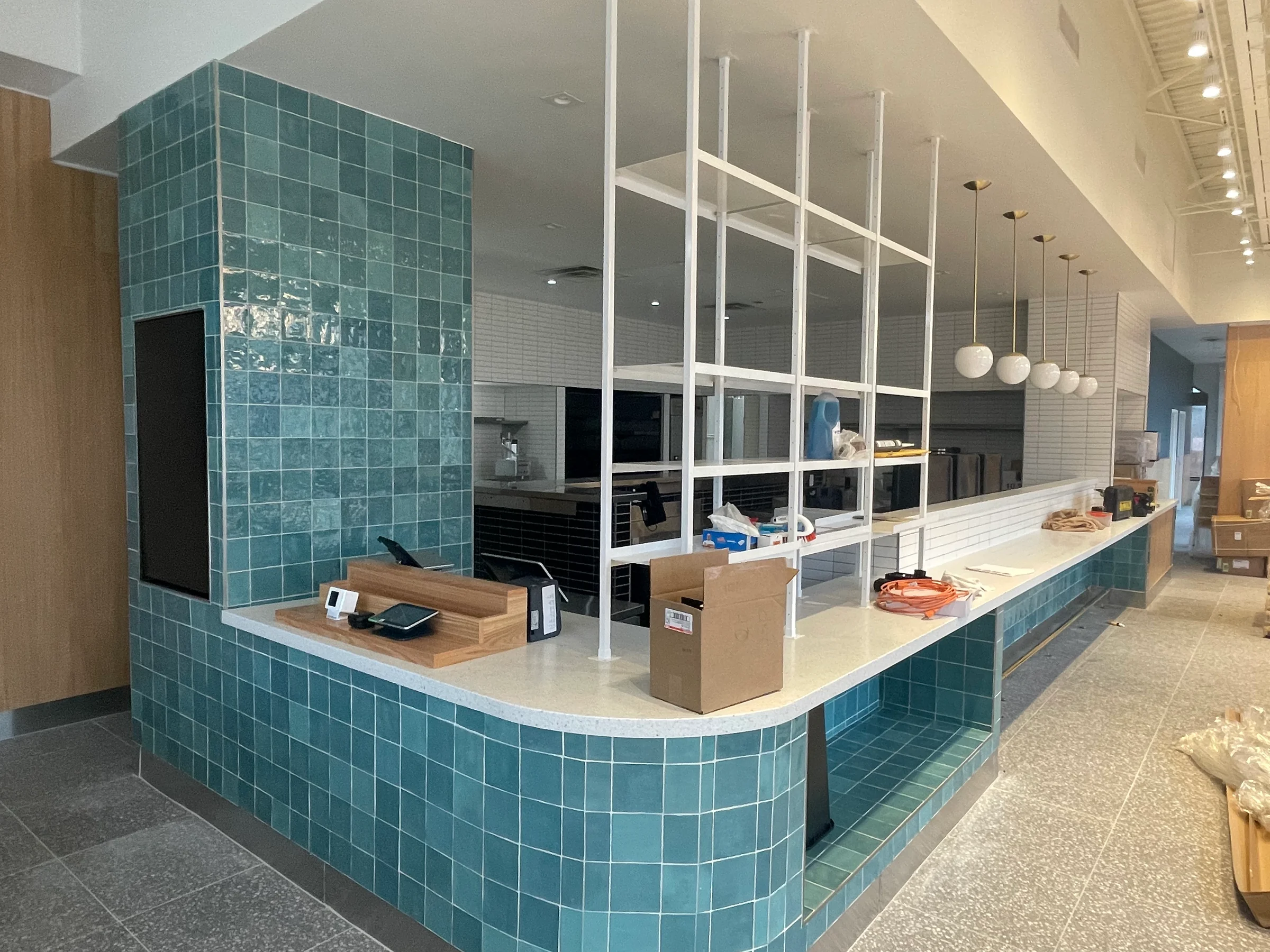 Commercial tenant interior taking shape around a tiled service counter